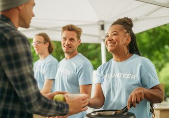 Volunteers feeding hungry people.