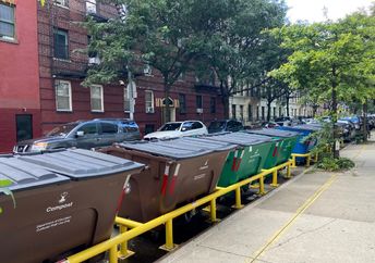 Curbside recycling and trash containers in NYC.