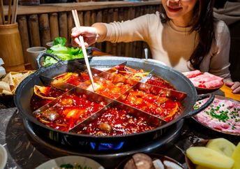 Woman eating original mala spicy hot pot