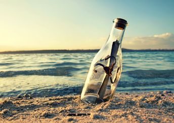 A message in a bottle on a beach.