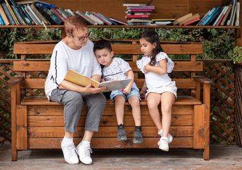 Grandmother reading to her grandchildren.