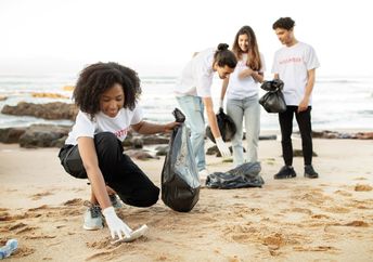 Young volunteers cleaning a beach.