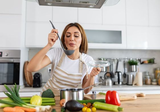 Woman cooking in a host kitchen.