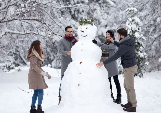 Friends building a snowman.