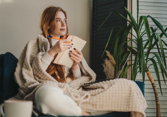 A woman writing in her journal.