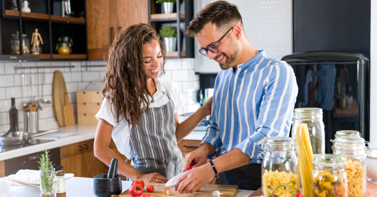 A couple cooking together.