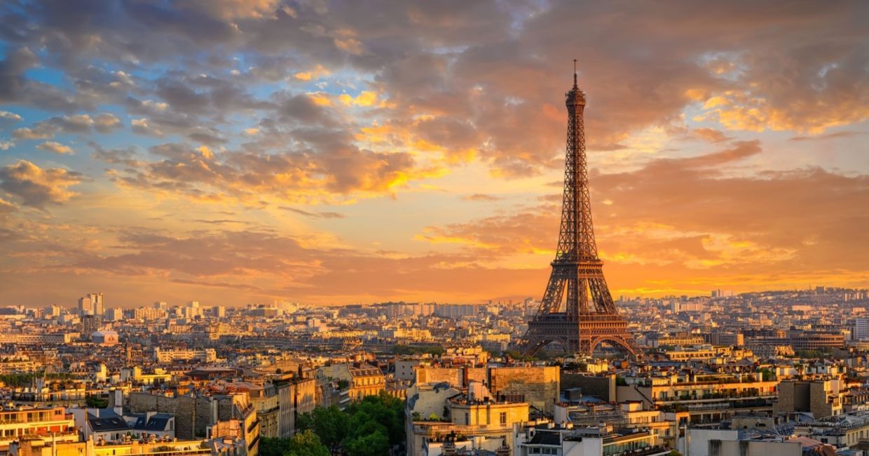 Skyline of Paris with the Eiffel Tower at sunset.