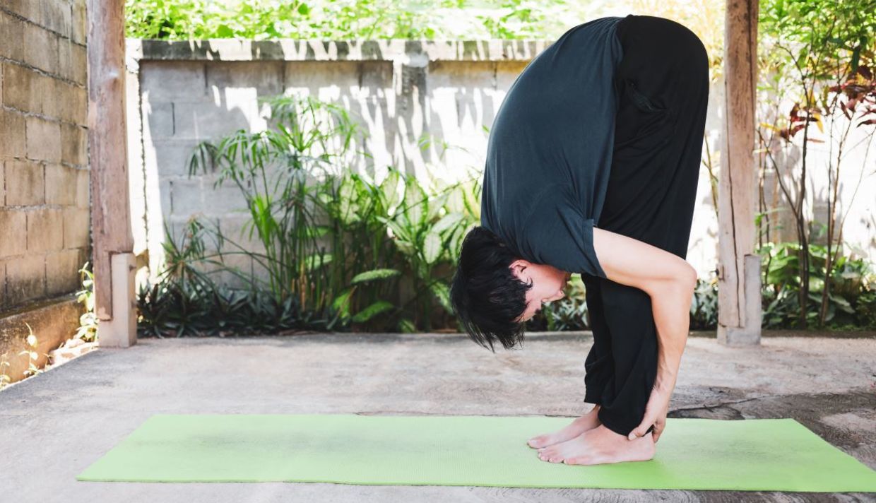 Man in the hasta uttanasanam yoga pose.