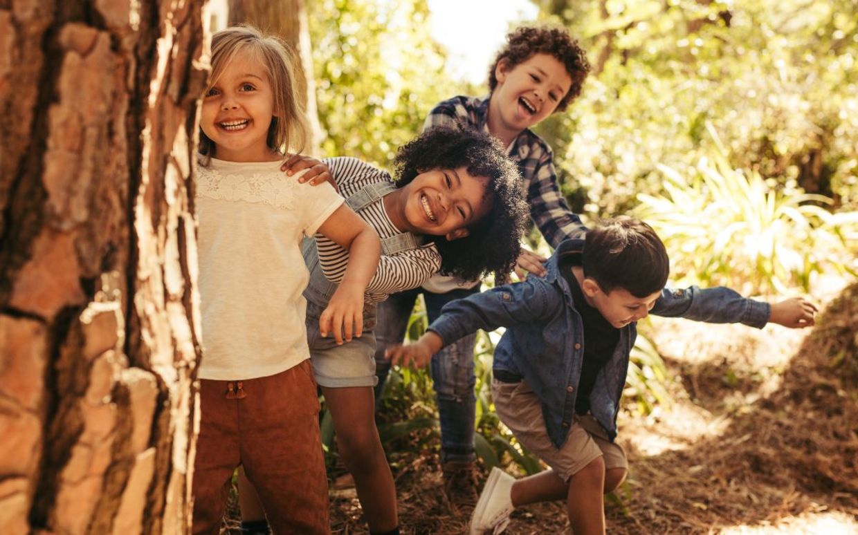 Children playing outside in nature.