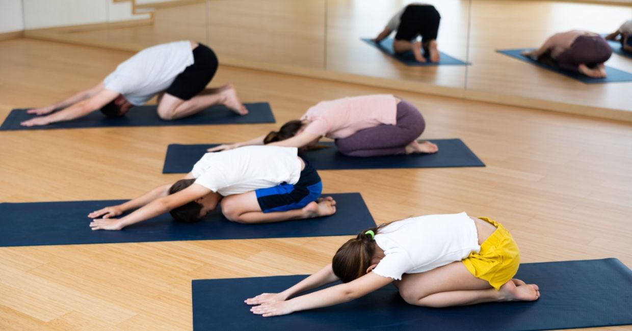 Parents and tweens doing yoga.