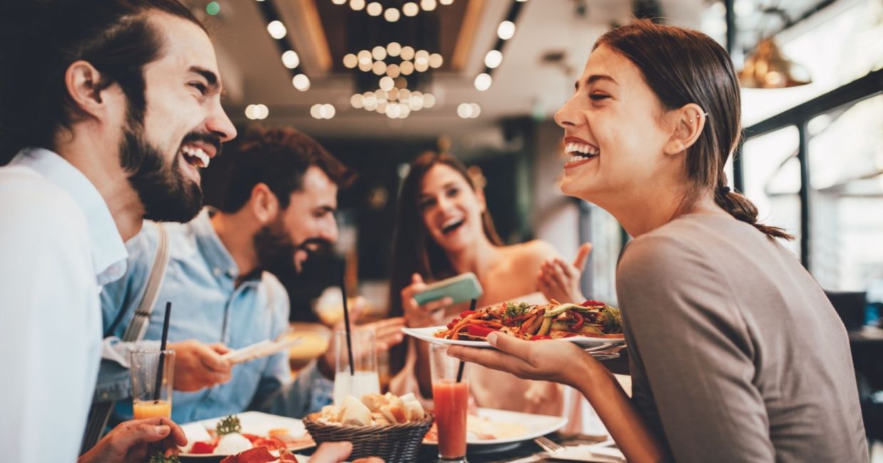 A group of happy friends eating out.