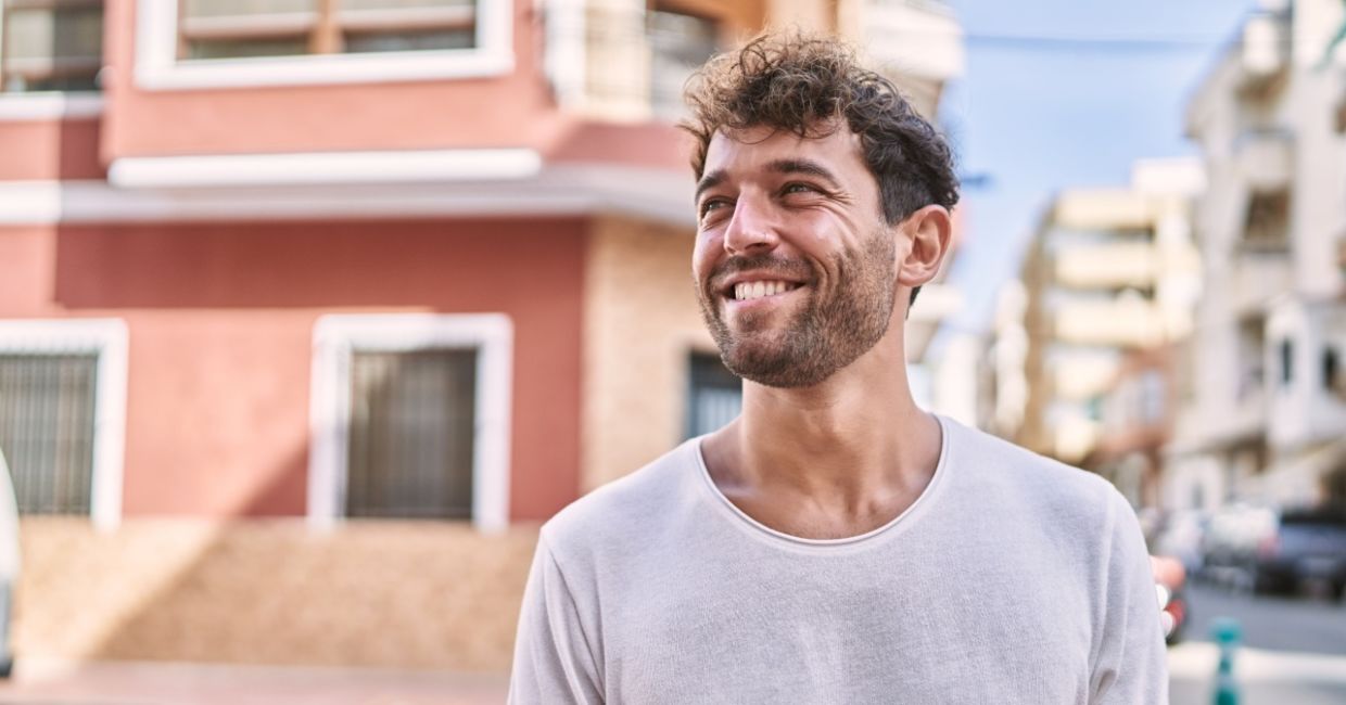 Young Spaniard walking along the street in the summertime.