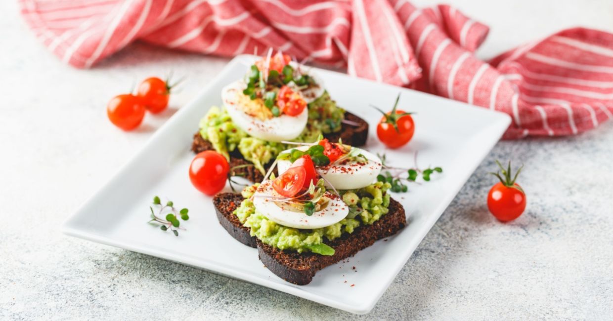 Mashed avocado and egg on rye toast.