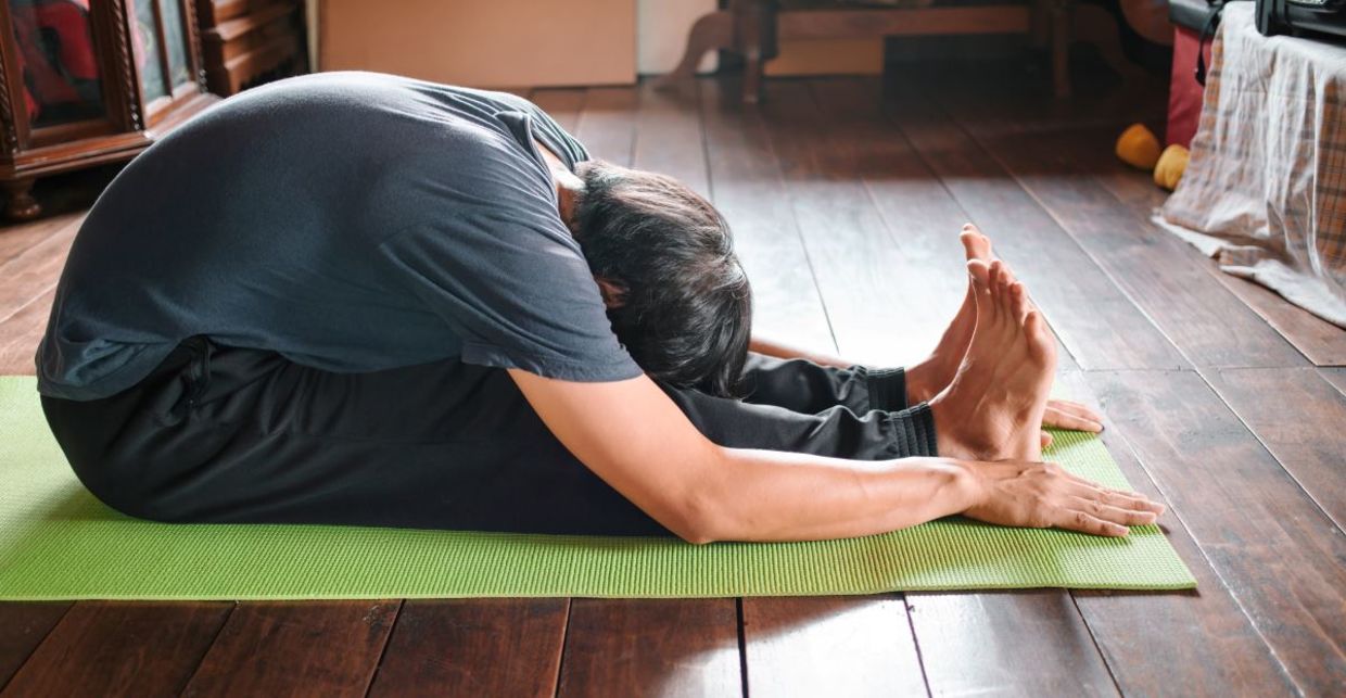 Relax in the seated forward bend yoga pose.