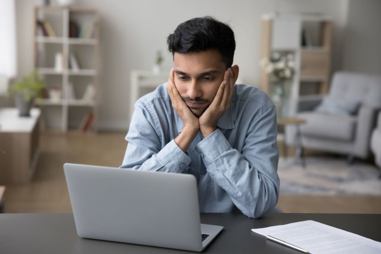 A man who is stuck in a procrastination cycle.