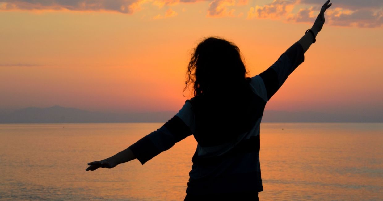 Woman enjoying the sunrise.