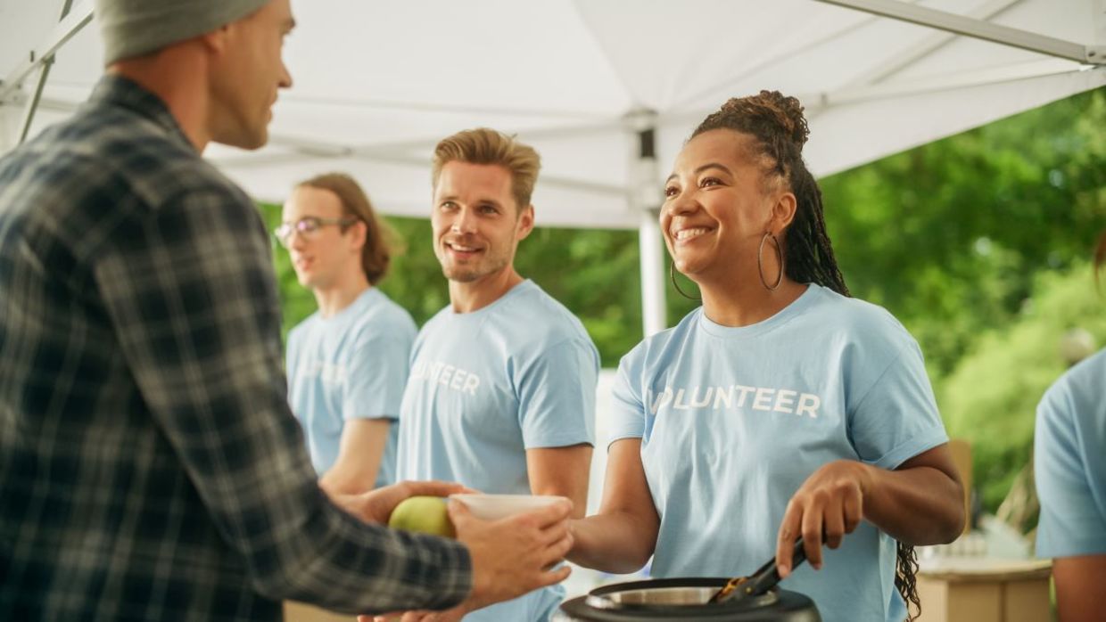 Volunteers feeding hungry people.