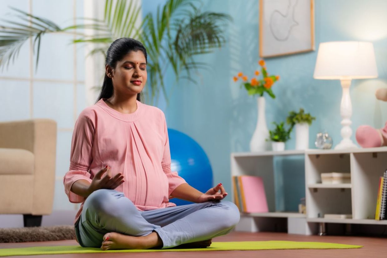 Modify the lotus pose during pregnancy.