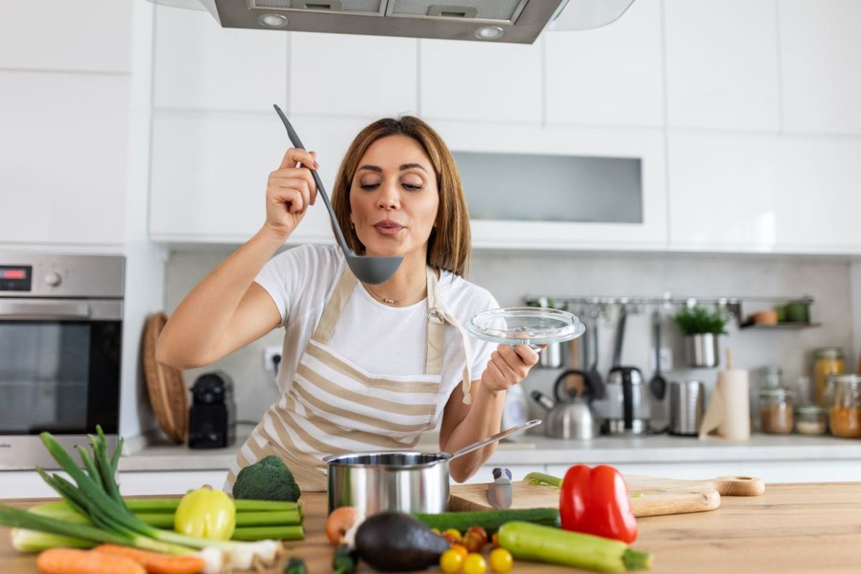 Woman cooking in a host kitchen.