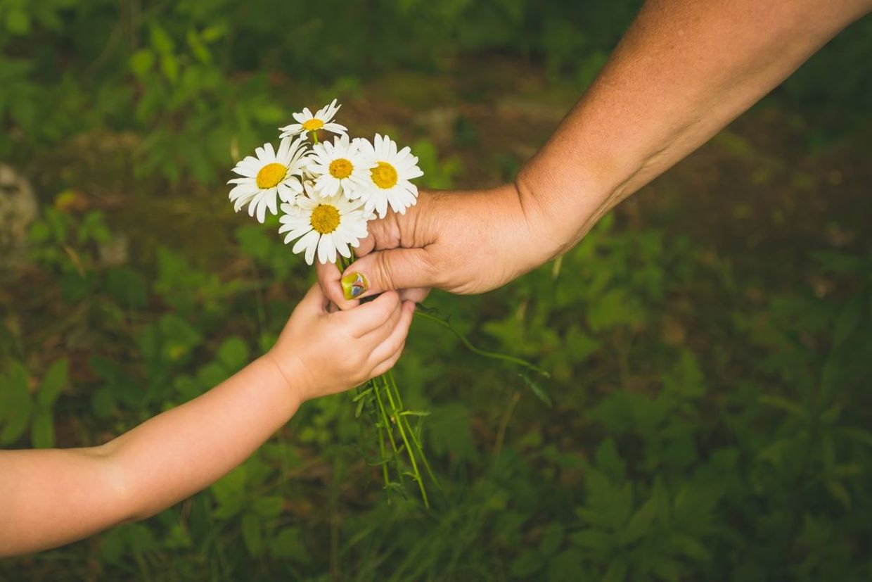 Giving flowers to a family member.