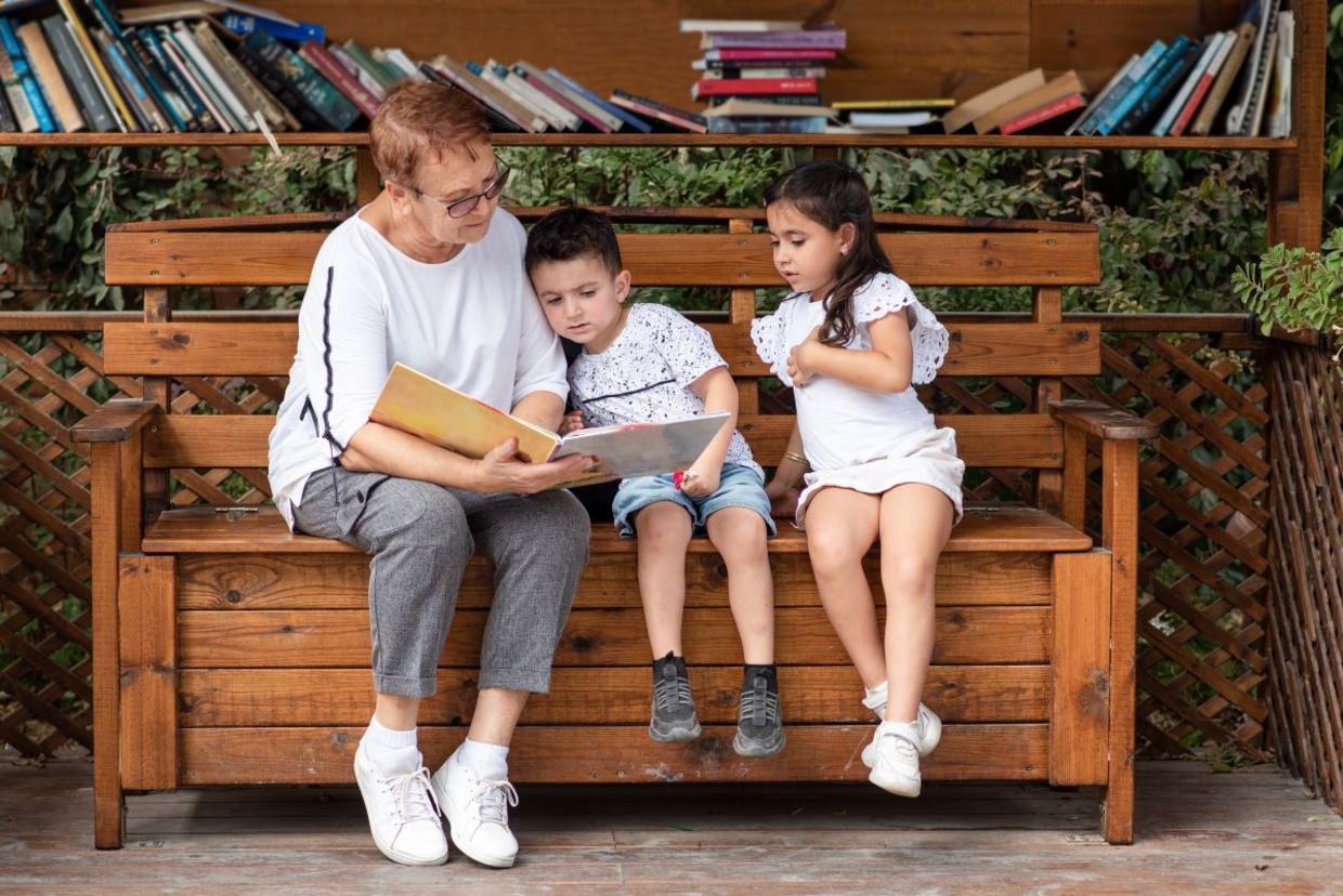 Grandmother reading to her grandchildren.