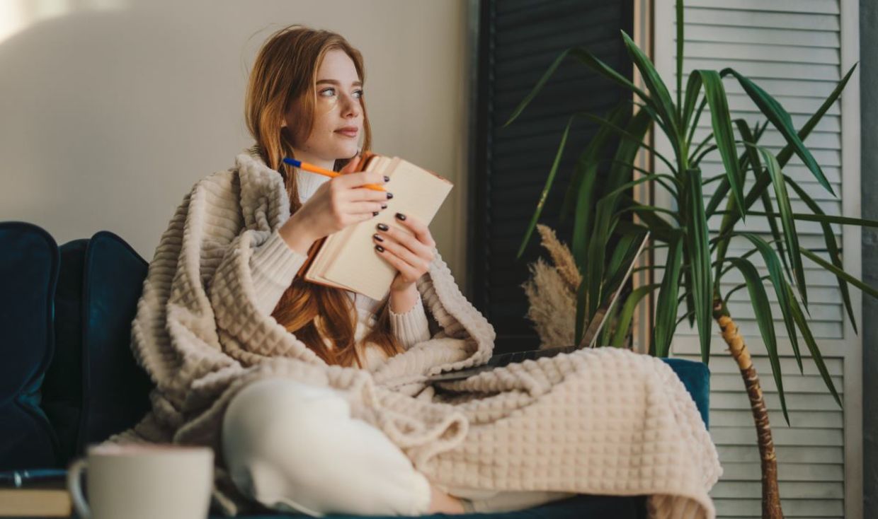 A woman writing in her journal.