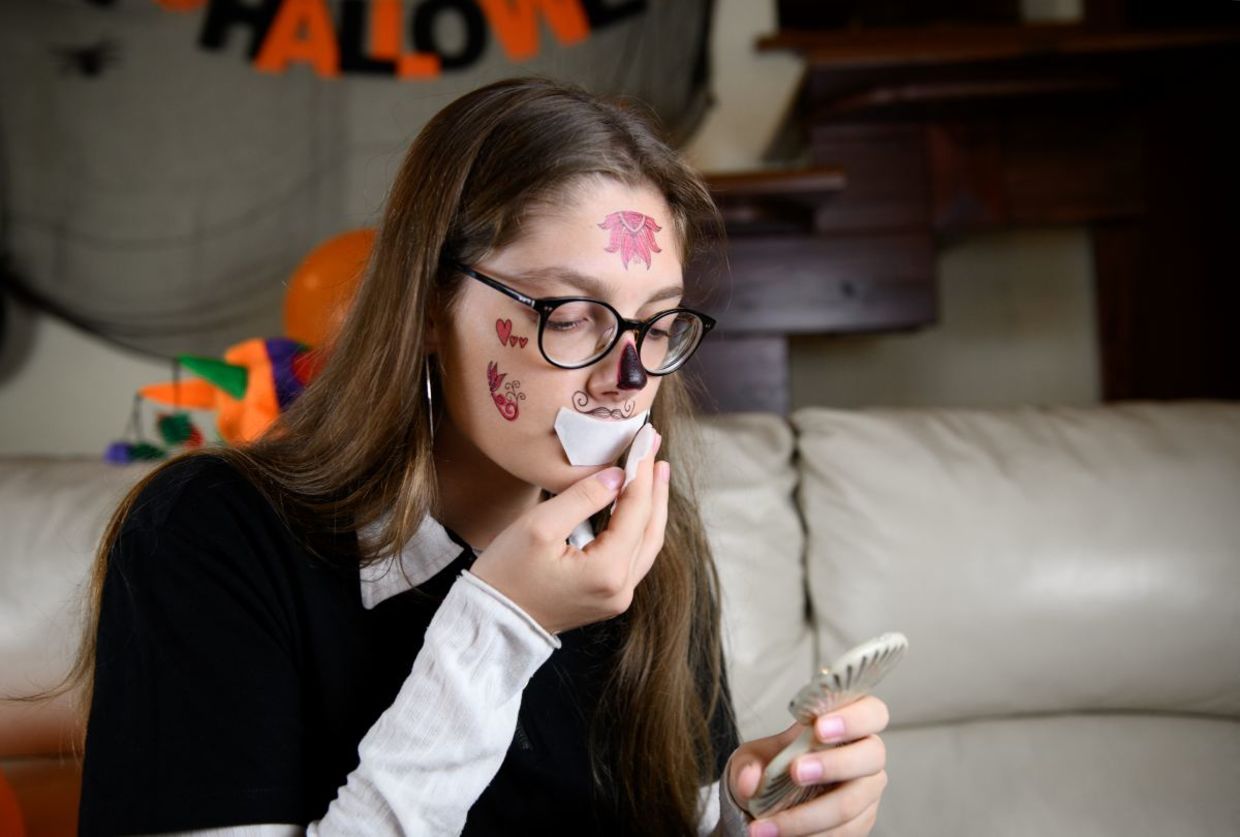 Applying scary Halloween tattoos. Applying scary Halloween tattoos.