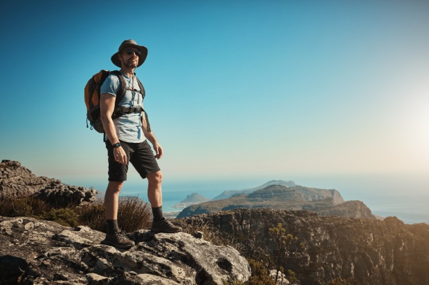 A man hikes with a backpack outdoors.
